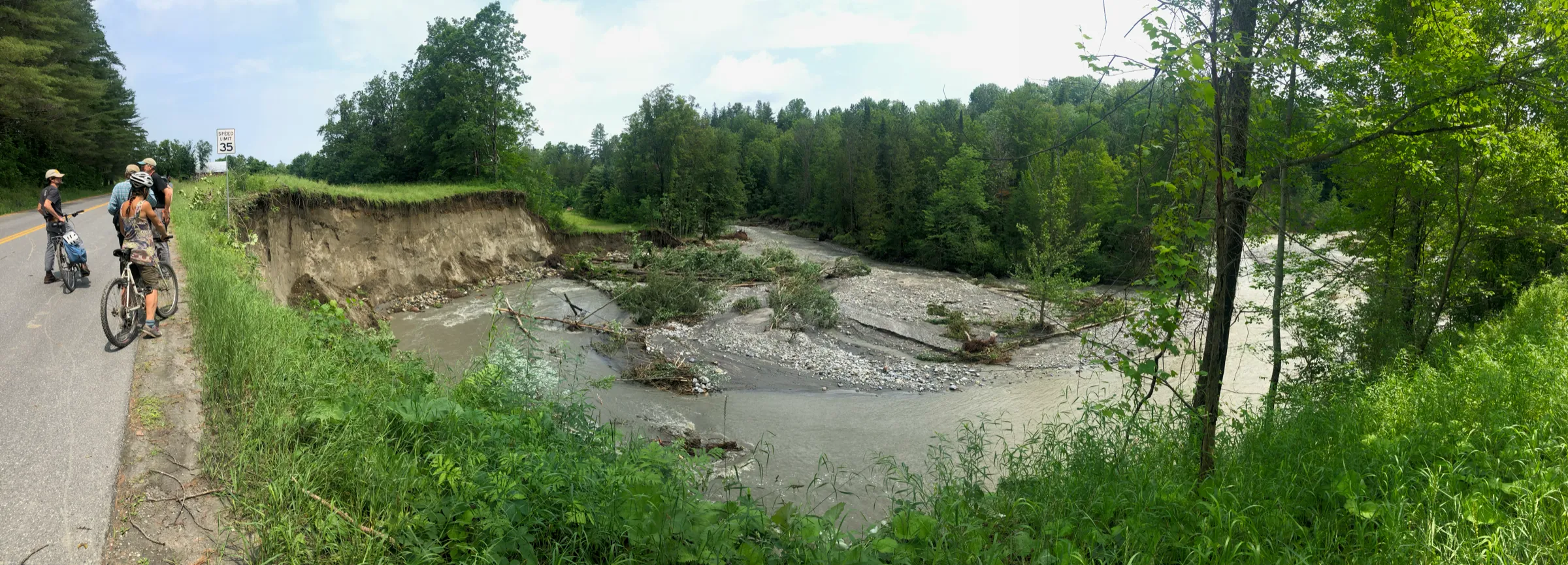 The Great Brook cutting off a meander, floodwater carving a new channel beside the gravel road.